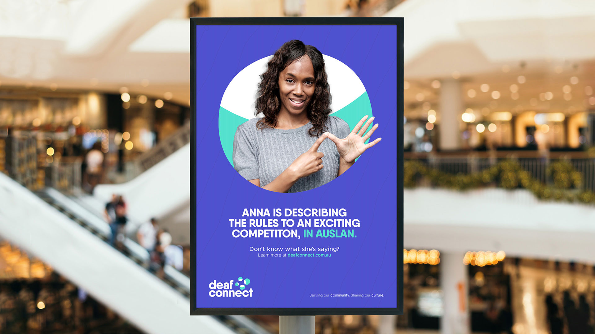 Digital billboard showcasing the new Deaf Connect brand identity. It reads "Anna is describing the rules to an exciting competition, in Auslan"