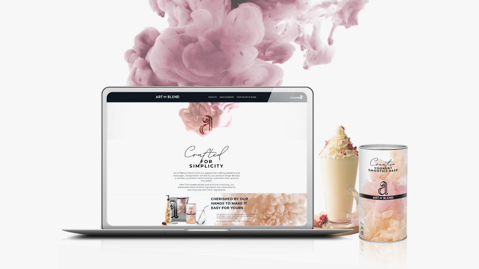 A laptop screen displaying the website for Art of Blend. On the right-hand side, there is a frappe coffee cup and a package of Art of Blend coffee mix.
